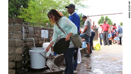 People queue to collect water from a natural spring in Cape Town, South Africa, Monday, Jan 22, 2018 as the city suffers from one of the worst droughts in recent history. Officials are looking to combat the drought, saying it was looking more likely that it will have to turn off most taps on &quot;Day Zero,&quot; or April 21 stating that 60 percent of residents are &quot;callously&quot; using more than the current limit and that the city will fine households that use too much water. (AP Photo/Anwa Essop)