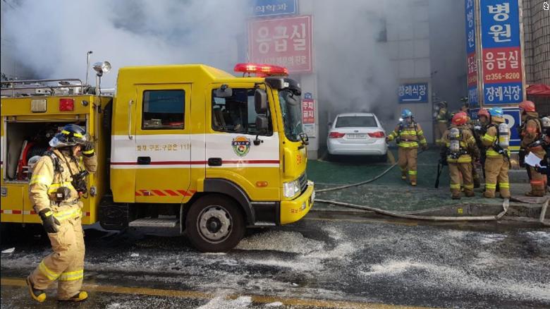 Firefighters work to put out the blaze as smoke billows from the Sejong Hospital, Friday.