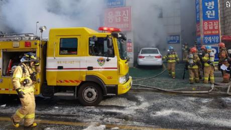 Firefighters work to put out the blaze as smoke billows from the Sejong Hospital, Friday.