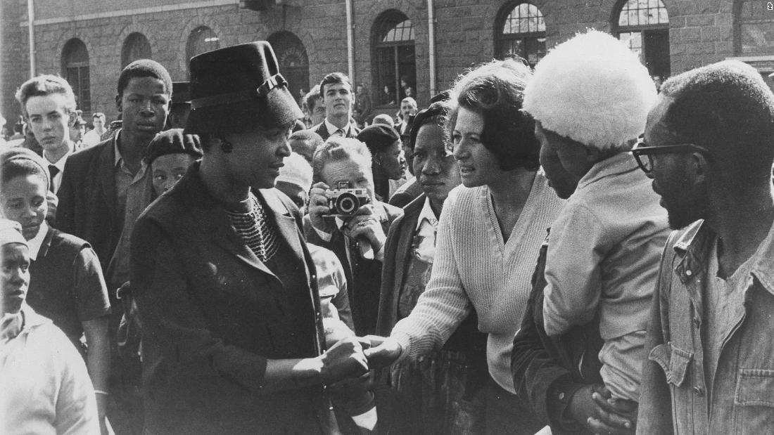 People gather in support of Madikizela-Mandela as she leaves a court in Pretoria, South Africa, in 1964. Her husband had just been sentenced to life in prison.