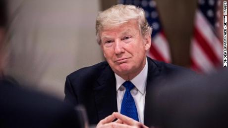 US President Donald Trump listens to a speaker during a working dinner with European business leaders during the World Economic Forum (WEF) annual meeting in Davos, eastern Switzerland, on January 25, 2018. / AFP PHOTO / NICHOLAS KAMM        