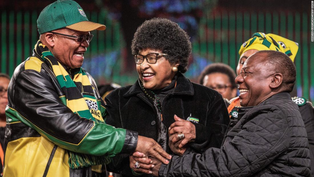 Madikizela-Mandela joins the hands of South African President &lt;a href=&quot;http://www.cnn.com/2018/02/08/africa/gallery/jacob-zuma-career/index.html&quot; target=&quot;_blank&quot;&gt;Jacob Zuma, &lt;/a&gt;left, and Deputy President Cyril Ramaphosa during an African National Congress policy conference in 2017.