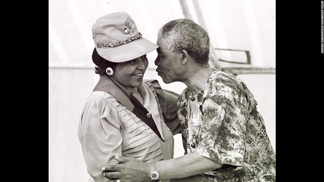 Mandela leans in to kiss his wife at a rally in March 1990.