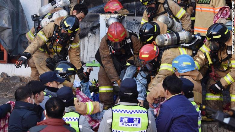 Rescue workers remove bodies from a hospital fire on January 26, 2018 in Miryang, South Korea.
