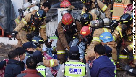 Rescue workers remove bodies from a hospital fire on January 26, 2018 in Miryang, South Korea.