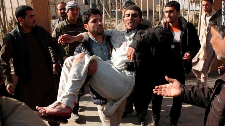 An injured man is carried away from the site of a deadly suicide attack Saturday in Kabul.