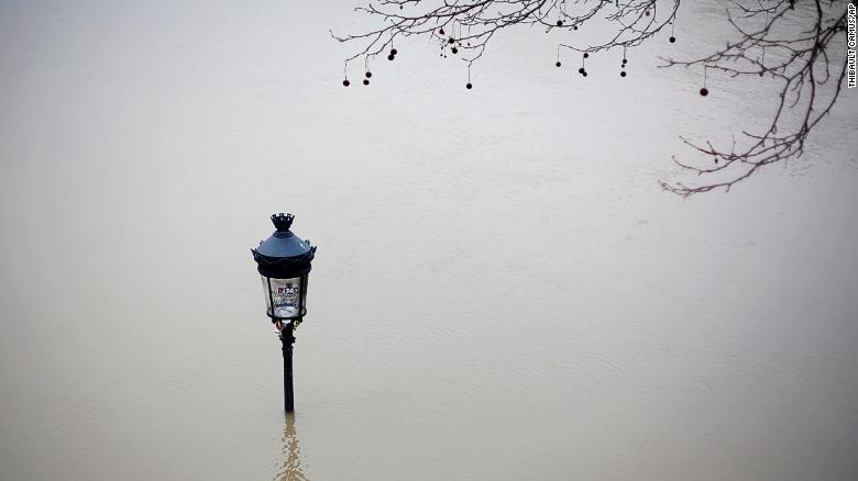 A street lamp is visible in floodwaters Saturday next to the Seine in Paris.