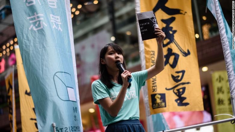 Pro-democracy Demosisto party member Agnes Chow speaks to passing pedestrians in Hong Kong on June 4, 2017.