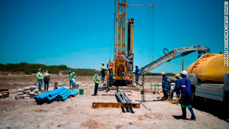 A team prepares a site where the Cape Town city council has ordered drilling into the aquifer to tap water, in Mitchells Plains, Cape Town. 