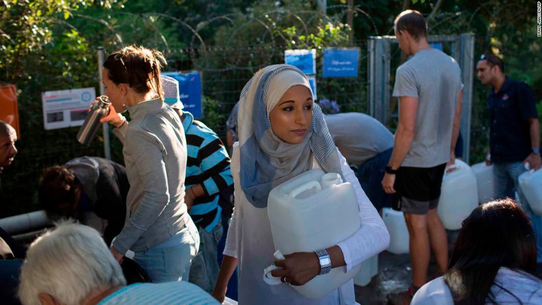 A woman waits to collect water on February 1. 