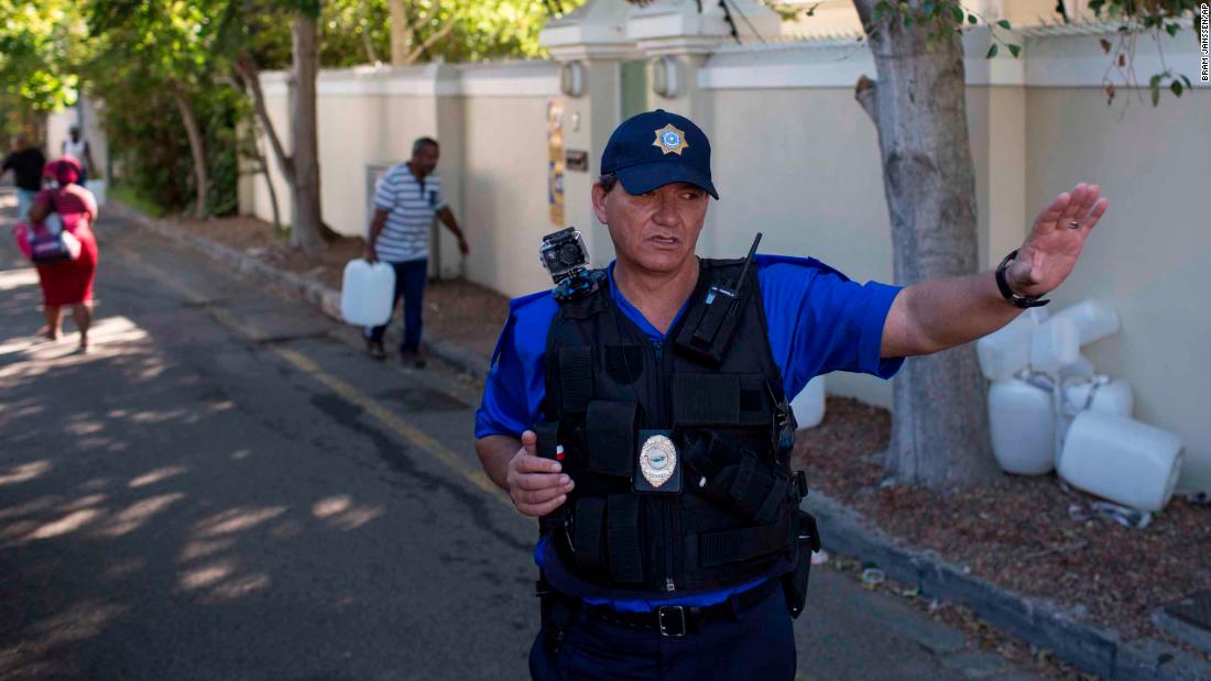 A police officer controls water collection on February 1.