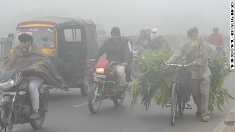 Indian commuters make their way through heavy smog in Amritsar in November, 2017.

