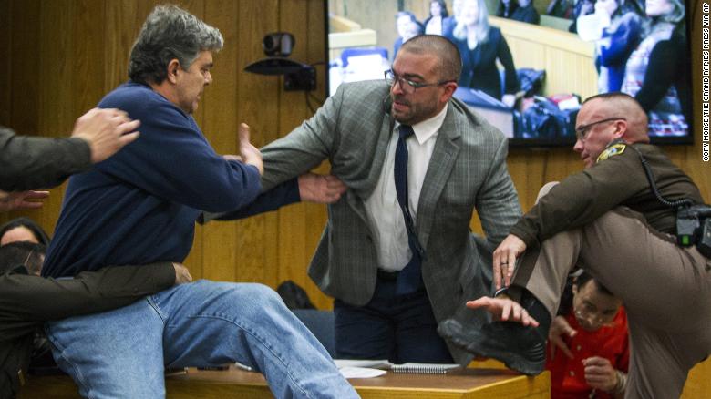 Randall Margraves, father of three victims of Larry Nassar, lunged at Nassar, bottom right, on Friday in Eaton County Circuit Court in Michigan.