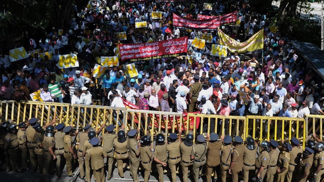 Sri Lankan police stand guard during a protest in Colombo against the lease of the loss-making Hambantota port to China, February 1, 2017.
