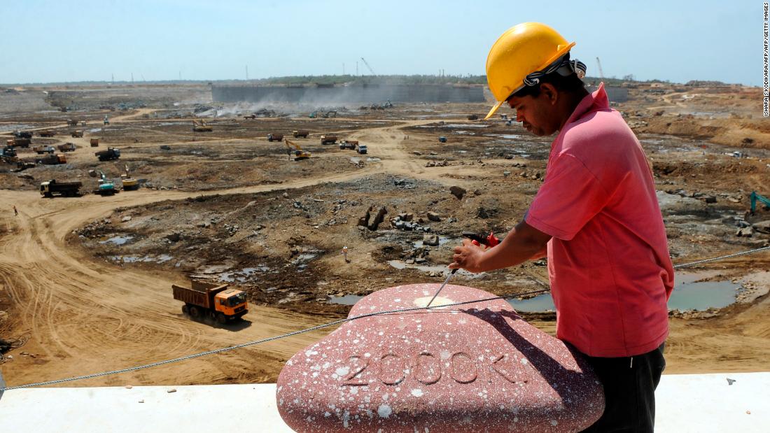 Construction workers operate heavy equipment at the base of Sri Lanka's Hambantota port August 1, 2010. Some 350 Chinese staff helped in the first phase of construction. 