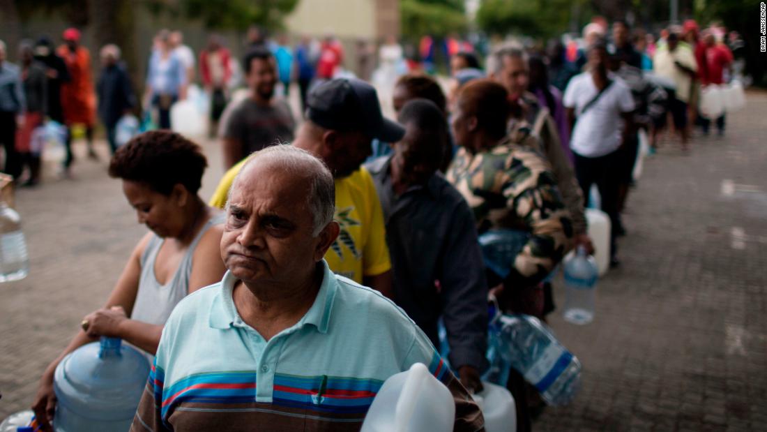 Residents queue to fill containers from a source of natural spring water in Cape Town, South Africa, February 2. The drought-hit city introduced new water restrictions in an attempt to avoid what it calls &quot;Day Zero,&quot; the day in mid-April when it might have to turn off most taps. 