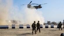 US troops walk as a US Army C-47 Chinook helicopter flies over the village of Oreij, south of Mosul, on February 22, 2017, where a temporary military base has been established for an assault on the city's west bank.
Iraqi forces readied on February 22, 2017 for an assault on Mosul airport after blitzing jihadist positions in a renewed offensive to retake the Islamic State group's emblematic stronghold. / AFP / AHMAD AL-RUBAYE        (Photo credit should read AHMAD AL-RUBAYE/AFP/Getty Images)