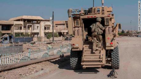 MOSUL, IRAQ - JUNE 21: A U.S. Army 82nd Airborne Division (2nd Brigade) team and an MRAP (mine-resistant vehicle) on June 21, 2017 in west Mosul, Iraq. The Division provides advise and assist support to Iraqi forces. (Martyn Aim/Getty Images)