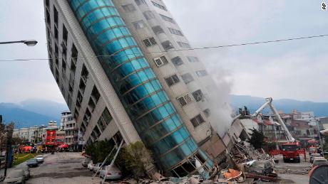 A residential building leans on a collapsed first floor following an earthquake, Wednesday, Feb. 7, 2018, in Hualien, southern Taiwan. Rescue crews continue to try free people from damaged buildings after a strong earthquake hit near Taiwan's east coast and killed at least four people. (Central News Agency via AP)
