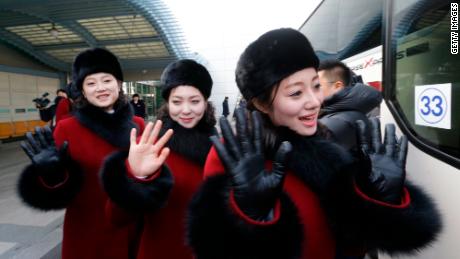 North Korean cheering squads wave upon arriving at the Korean-transit office near the Demilitarized Zone that divides the two Koreas Thursday.