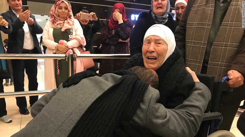 Amer Adi falls to his knees as he reunites with his mother for the first time in 20 years.