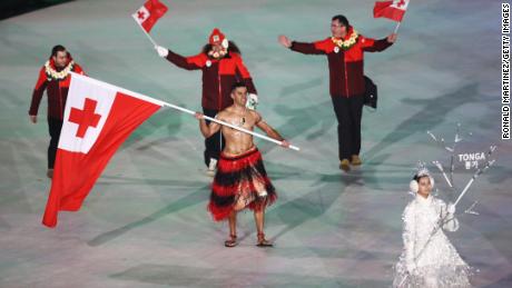 Flag bearer Pita Taufatofua of Tonga leads the team during the opening ceremony.