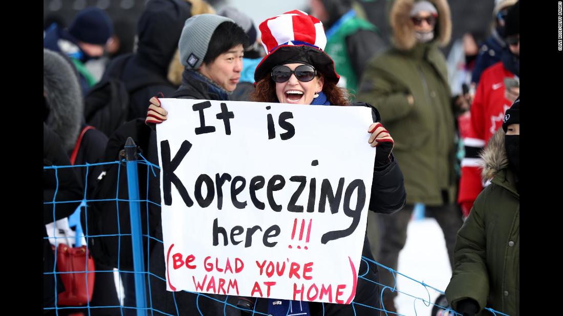 A spectator holds a sign at the men&#39;s snowboarding slopestyle final.
