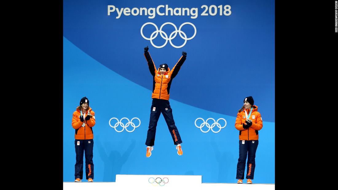 Gold medallist Carlijn Achtereekte of the Netherlands, center, celebrates on the podium with silver medalist Ireen Wust  and bronze medalist Antoinette de Jong during the ceremony for the woman&#39;s speed skating 3000m.
