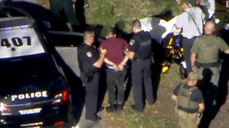 Law enforcement detain the suspect in Wednesday&#39;s school shooting.