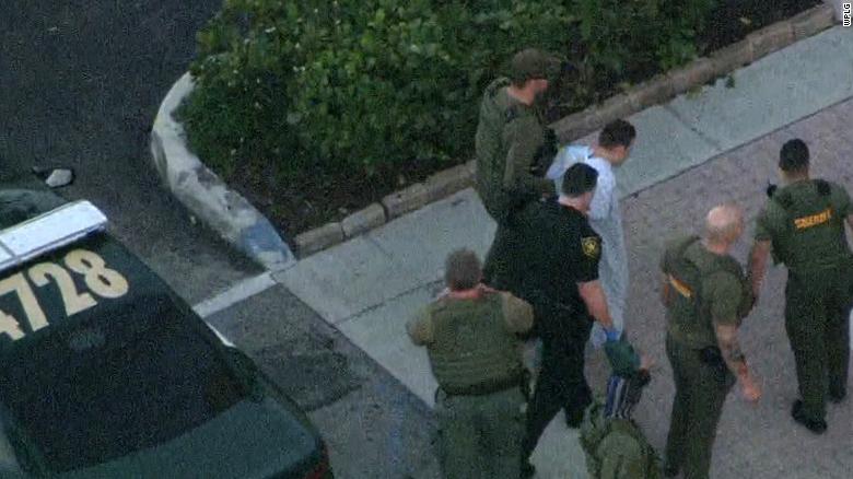 Law enforcement agents transport the suspect in Wednesday&#39;s school shooting.