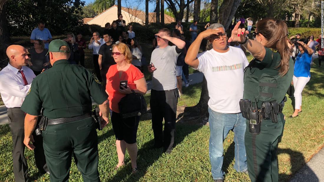 Security instructs parents following the shooting. Parents were told they would be reunited with their children at a local Marriott Hotel.