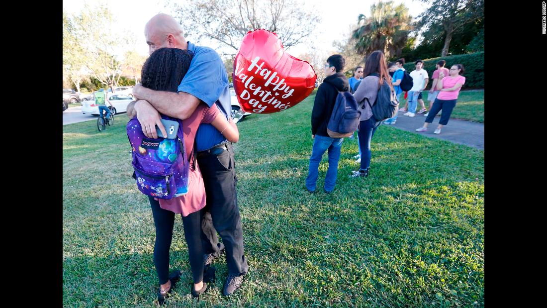 Family members embrace after shooting.