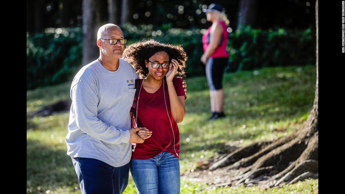 A father and daughter embrace after a mass shooting at the Marjory Stoneman Douglas High School.
