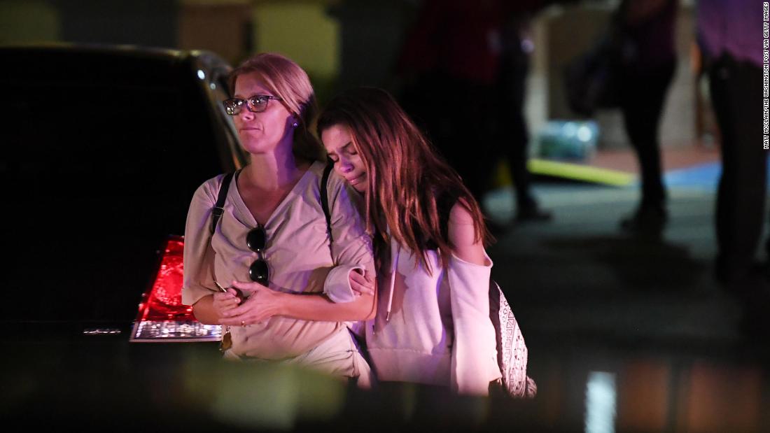 People embrace while leaving the Fort Lauderdale Marriott Coral Springs Hotel, which authorities designated as a staging point for witnesses to the shooting. 