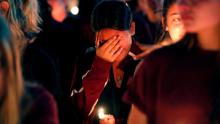 A woman cries during a candlelight vigil for the victims of the Wednesday shooting at Marjory Stoneman Douglas High School, in Parkland, Fla., Thursday, Feb. 15, 2018. Nikolas Cruz, a former student, was charged with 17 counts of premeditated murder on Thursday. (AP Photo/Gerald Herbert)