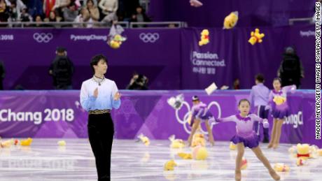 Fans throw gifts on to the ice for Yuzuru Hanyu after his routine during the men's short program at Gangneung Ice Arena.