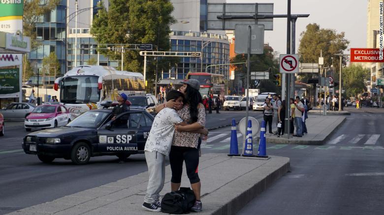 A woman embraces a boy during a powerful earthquake in Mexico City on February 16, 2018. 