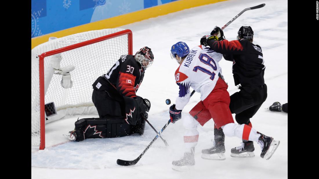 Dominik Kubalik of the Czech Republic shoots the puck against Canada&#39;s Ben Scrivens during a preliminary round hockey game.