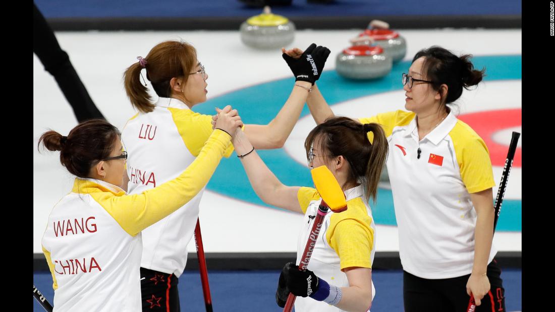 The women&#39;s curling team from China celebrates after a win over Japan.