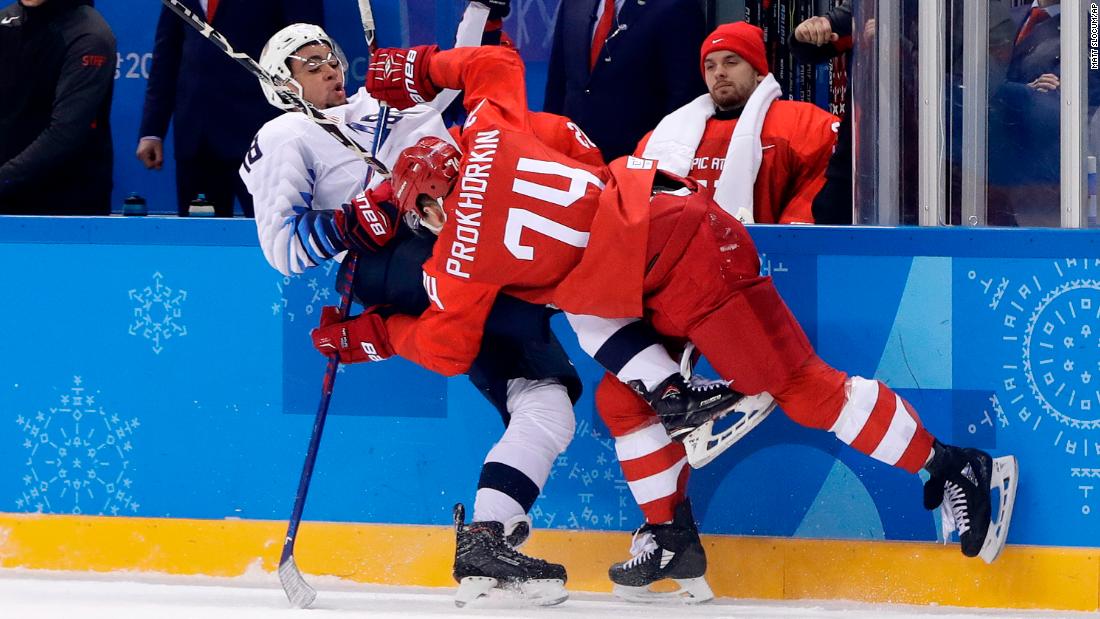 American Jordan Greenway gets checked by Russian Nikolai Prokhorkin during the preliminary round of play. The Olympic Athletes from Russia imposed their will in a 4-0 men&#39;s hockey win over the United States.