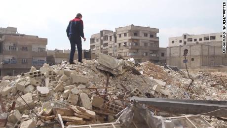 Najem surveys the damage in his neighborhood. 