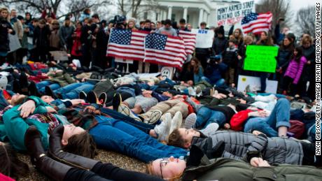 WASHINGTON, DC - FEBRUARY 19: Demonstrators lie on the ground a "lie-in" demonstration supporting gun control reform near the White House on February 19, 2018 in Washington, DC.  According to a statement from the White House, "the President is supportive of efforts to improve the Federal background check system.", in the wake of last weeks shooting at a high school in Parkland, Florida. (Photo by Zach Gibson/Getty Images)