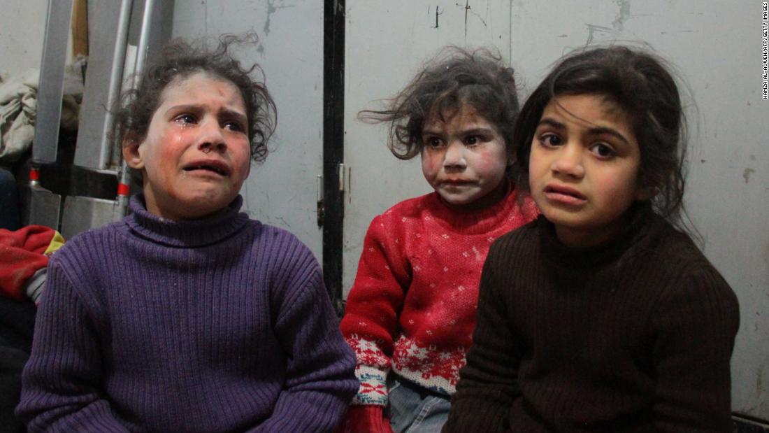 Children cry at a makeshift hospital in Douma.