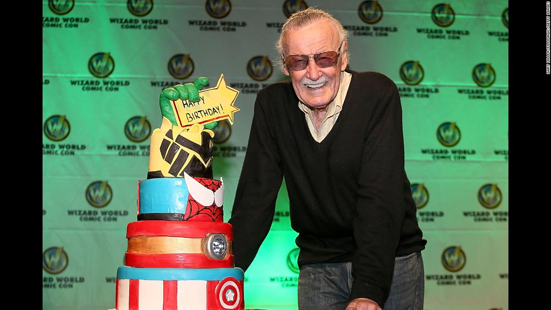 Lee is presented with a birthday cake for his 91st birthday in 2013.