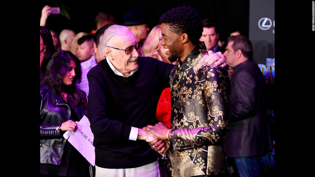 Lee shakes hands with &quot;Black Panther&quot; star Chadwick Boseman at the film&#39;s premiere in January 2018.