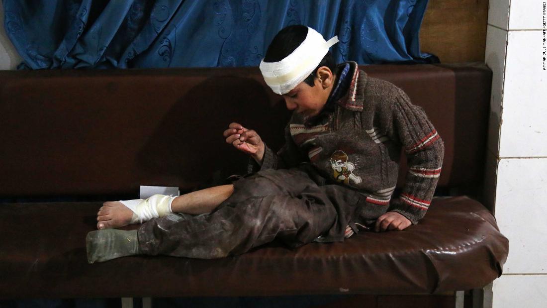 Ghaith, a wounded 12-year-old boy, cries as he waits for treatment -- and news of his mother in the operating room -- at a makeshift hospital in Kafr Batna. They were hurt in airstrikes on the town of Jisreen.