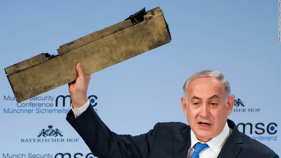 Netanyahu, speaking at a security conference in Germany in February 2018, holds up what he claimed was a piece of an Iranian drone that was shot down after it flew over Israeli territory.