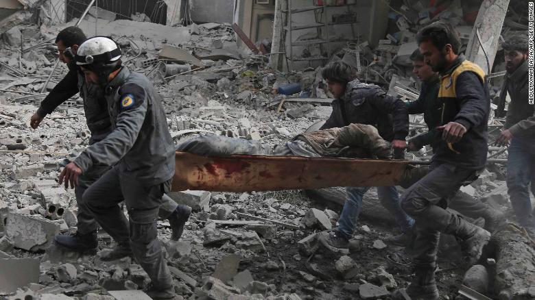 Syrian rescue workers carry an injured civilian on a stretcher from an area hit by a reported regime airstrike in the rebel-held town of Saqba, in Eastern Ghouta, on Tuesday.