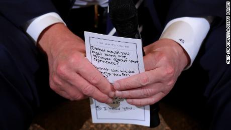 President Donald Trump holds his notes while hosting a listening session with students survivors of mass shootings, their parents and teachers in the State Dining Room at the White House on February 21, 2018 in Washington, DC.