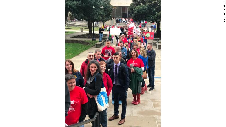 Teachers wait in line to get into the capitol building in Charleston.